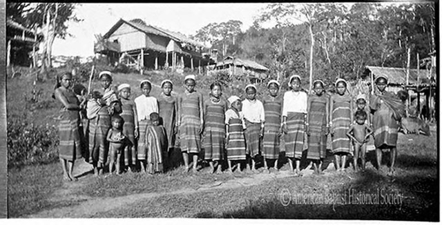 Sainbaung Chin women and children in native garb, at Ainbu Ywathit (the new Ainbu village), in Kyaukphyu District [Arakan State]. Note the carrying slings for infants. December 24, 1935. 
