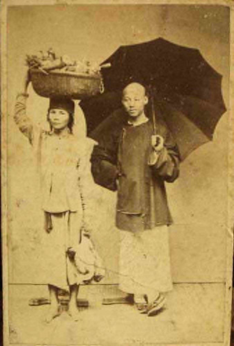 Fig. 11. Pun Lun, Studio Photograph of people from Saigon, 1880, (a market woman carrying goods on her head and probably a Chinese merchant with an umbrella). 