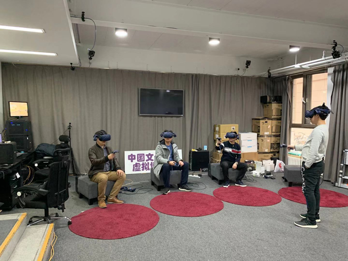 Alt-text: Four men using VR headsets Alt-text: Four men using VR headsets