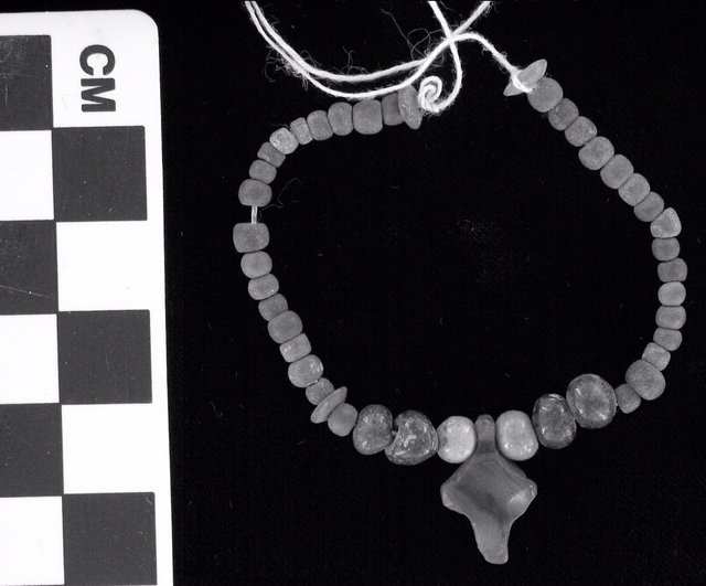 Fig. 1. Necklace of faience beads with carnelian amulet, ca. 1570-1293 BCE (Eighteenth Dynasty), from Gurob, Egypt, 12.2 x 2 cm. William Flinders Petrie Donation, 1921, KM 1879. Fig. 1. Necklace of faience beads with carnelian amulet, ca. 1570-1293 BCE (Eighteenth Dynasty), from Gurob, Egypt, 12.2 x 2 cm. William Flinders Petrie Donation, 1921, KM 1879.