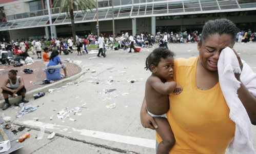 ©Associated Press - A WOMAN CRIES AS SHE WAITS WITH OTHER FLOOD VICTIMS AT THE CONVENTION CENTER IN NEW ORLEANS, THURSDAY, SEPT. 1, 2005. OFFICIALS CALLED FOR A MANDATORY EVACUATION OF THE CITY, BUT MANY RESIDENTS REMAINED IN THE CITY AND HAD TO BE RESCUED FROM FLOODED HOMES AND HOTELS AND REMAIN IN THE CITY AWAITING A WAY OUT. (APPHOTO/ERIC GAY) ©Associated Press - A WOMAN CRIES AS SHE WAITS WITH OTHER FLOOD VICTIMS AT THE CONVENTION CENTER IN NEW ORLEANS, THURSDAY, SEPT. 1, 2005. OFFICIALS CALLED FOR A MANDATORY EVACUATION OF THE CITY, BUT MANY RESIDENTS REMAINED IN THE CITY AND HAD TO BE RESCUED FROM FLOODED HOMES AND HOTELS AND REMAIN IN THE CITY AWAITING A WAY OUT. (APPHOTO/ERIC GAY)