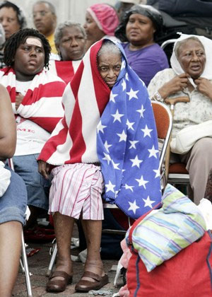 ©Associated Press - MILVERTHA HENDRICKS, 84, CENTER WAITS IN THE RAIN WITH OTHER FLOOD VICTIMS OUTSIDE THE CONVENTION CENTER IN NEW ORLEANS, THURSDAY, SEPT. 1, 2005. OFFICIALS CALLED FOR A MANDATORY EVACUATION OF THE CITY, BUT MANY RESIDENTS REMAINED IN THE CITY AND HAD TO BE RESCUED FROM FLOODED HOMES AND HOTELS AND REMAIN IN THE CITY AWAITING A WAY OUT. (AP PHOTO/ERIC GAY) ©Associated Press - MILVERTHA HENDRICKS, 84, CENTER WAITS IN THE RAIN WITH OTHER FLOOD VICTIMS OUTSIDE THE CONVENTION CENTER IN NEW ORLEANS, THURSDAY, SEPT. 1, 2005. OFFICIALS CALLED FOR A MANDATORY EVACUATION OF THE CITY, BUT MANY RESIDENTS REMAINED IN THE CITY AND HAD TO BE RESCUED FROM FLOODED HOMES AND HOTELS AND REMAIN IN THE CITY AWAITING A WAY OUT. (AP PHOTO/ERIC GAY)