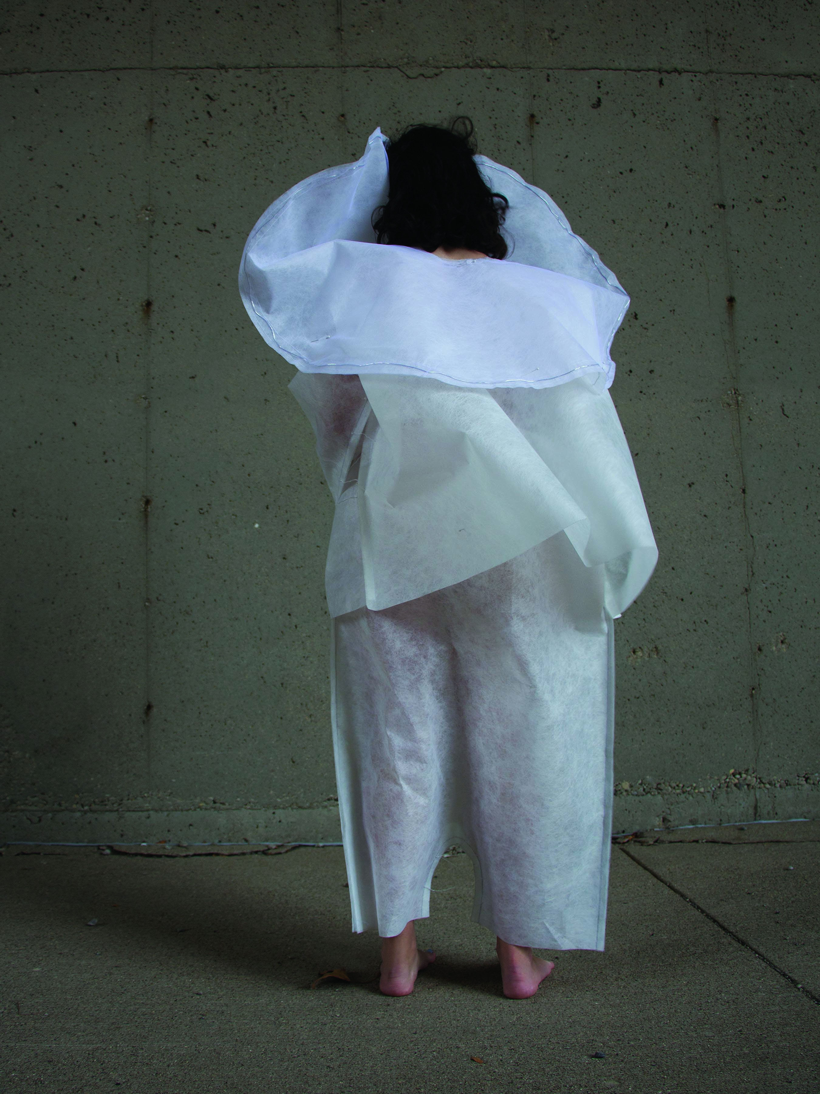 Figures 3-4: Unisuit by Margy Groshong (BDes, Fashion Design), 2016. Unisuit proposes an embrace of homogeneous external appearances, favoring what happens uniquely within the human mind. In an age of explosive research and discovery in neuroscience, it suggests a society so focused on the value and functions of the brain that other forms of human ability are intentionally limited. Walking, use of hands, and vision of the wearer are all obstructed while face and body shape are hidden. Only the top and back of the head are revealed — an indication that the brain is coveted. From the theme “Yearning for an Authentic Self” in the exhibition Dread & Desire: Urban Futures at the Scale of the Human Body.