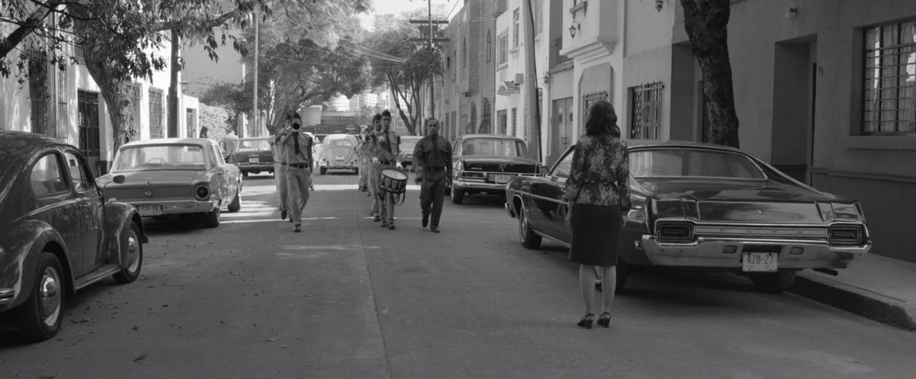 Figure 2: Lovesick Sofia (Marina de Tavira) watches as her husband (Fernando Gregiada) drives off in his Beetle, while the shrillness of a drum and bugle corps only adds to her torment. Figure 2: Lovesick Sofia (Marina de Tavira) watches as her husband (Fernando Gregiada) drives off in his Beetle, while the shrillness of a drum and bugle corps only adds to her torment.