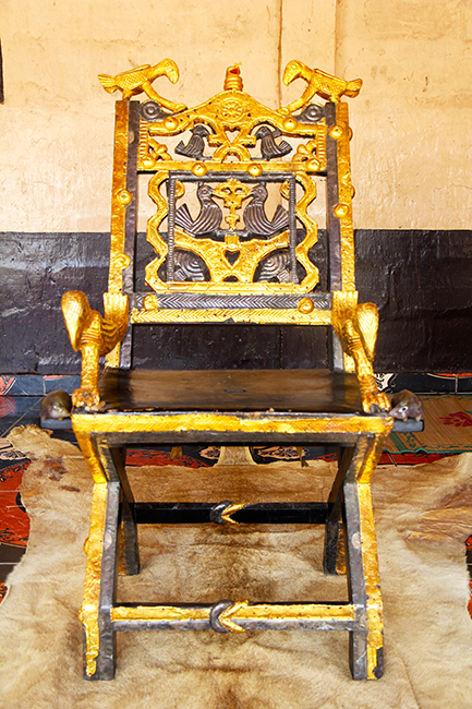 Description: Kɔdeɛ (the eagle) on both sides of the backrest with nankabɔbɔnini (a coiled gabbon viper). Like the gaboon viper, the Asantehene will never attack or fight without provocation. Directly below the viper is tadeɛ (a lake). Description: Kɔdeɛ (the eagle) on both sides of the backrest with nankabɔbɔnini (a coiled gabbon viper). Like the gaboon viper, the Asantehene will never attack or fight without provocation. Directly below the viper is tadeɛ (a lake).
