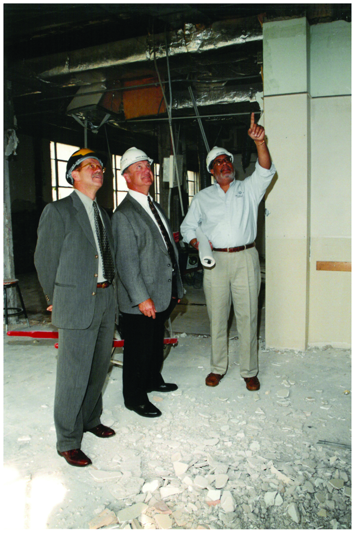 Dean William Kotowicz (L) and Assistant Dean Arnold Morowa with Gary Owens (R) scan construction details during the Kellogg Building renovation project. Dean William Kotowicz (L) and Assistant Dean Arnold Morowa with Gary Owens (R) scan construction details during the Kellogg Building renovation project.