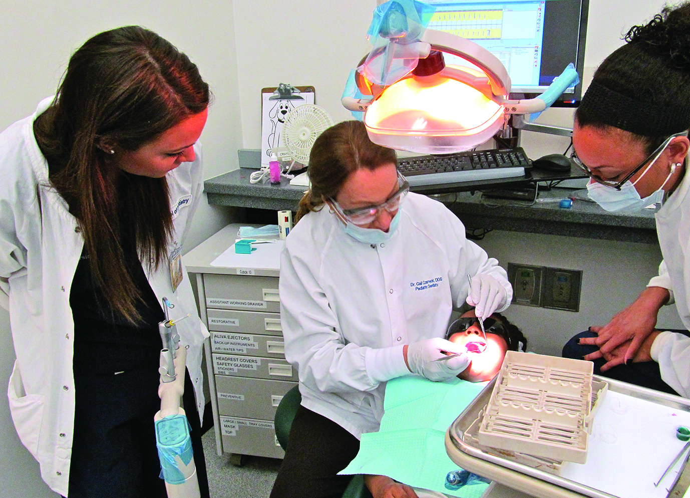 As part of the interprofessional education initiative, Dr. Gail Czarnecki, clinical assistant professor, Department of Orthodontics and Pediatric Dentistry, developed a dental-focused program to allow nursing students to shadow dental students, residents, and faculty dentists in the pediatric dental clinic. As part of the interprofessional education initiative, Dr. Gail Czarnecki, clinical assistant professor, Department of Orthodontics and Pediatric Dentistry, developed a dental-focused program to allow nursing students to shadow dental students, residents, and faculty dentists in the pediatric dental clinic.