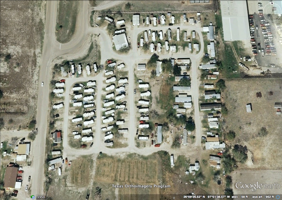 Figure 1: Aerial view of a colonia near Mercedes, Texas in the Lower Rio Grande Valley. This aerial depicts the layout of a typical colonia, showing a mixture of housing types: second-hand mobile homes, repurposed airstreams, and makeshift shacks. To get a sense of the small sizes of the homes and lots, consider the sizes of the homes in relation to the cars parked beside them. Note that this colonia has only partially paved roads. Figure 1: Aerial view of a colonia near Mercedes, Texas in the Lower Rio Grande Valley. This aerial depicts the layout of a typical colonia, showing a mixture of housing types: second-hand mobile homes, repurposed airstreams, and makeshift shacks. To get a sense of the small sizes of the homes and lots, consider the sizes of the homes in relation to the cars parked beside them. Note that this colonia has only partially paved roads.