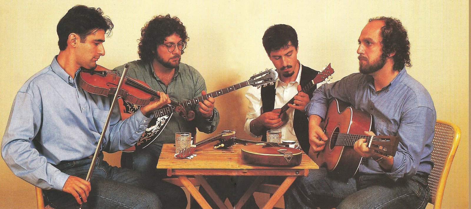 Figure 2. Apodimi Compania (1992): (left to right) Hector Cosmas, Manuel Galiatsos, Archie Argyropoulos, George Galiatsos. (Photograph Geoff Hollings. Used with permission of Brunswick Recordings.) Apodimi Compania was a successful and highly skilled group of young Greek-Australian rebetika players in Melbourne, active from 1984 to the mid-1990s. Figure 2. Apodimi Compania (1992): (left to right) Hector Cosmas, Manuel Galiatsos, Archie Argyropoulos, George Galiatsos. (Photograph Geoff Hollings. Used with permission of Brunswick Recordings.) Apodimi Compania was a successful and highly skilled group of young Greek-Australian rebetika players in Melbourne, active from 1984 to the mid-1990s.