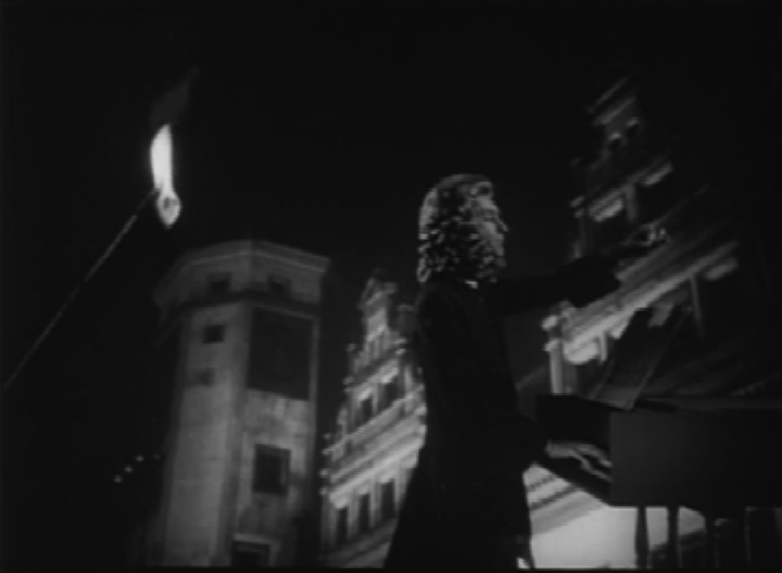 Figure 1.: Gustav Leonhardt as J.S. Bach, shown conducting with rear projection of the St. Thomas School (shot 57). Figure 1.: Gustav Leonhardt as J.S. Bach, shown conducting with rear projection of the St. Thomas School (shot 57).
