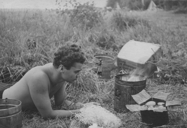 From H. P. (Pierre) Secher's album. At the beach: Emil (Mümmel) stirring the fire in his self-made oven. From H. P. (Pierre) Secher's album. At the beach: Emil (Mümmel) stirring the fire in his self-made oven.