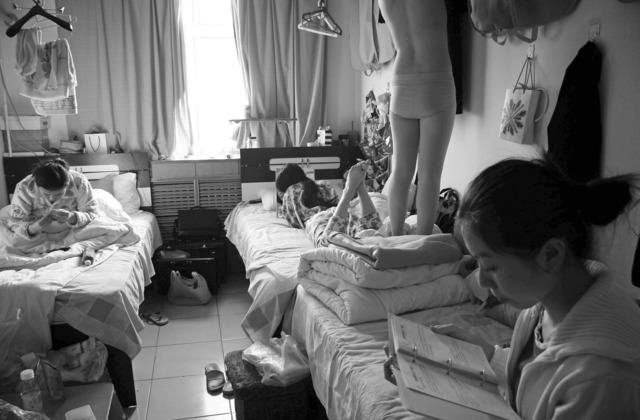 Wang Lin, “Three girls resting in the dorm; one, just returned from flight, hanging her uniform” from Heaven & Earth series, Tianjin, 2008, 40x50cm. Wang Lin, “Three girls resting in the dorm; one, just returned from flight, hanging her uniform” from Heaven & Earth series, Tianjin, 2008, 40x50cm.