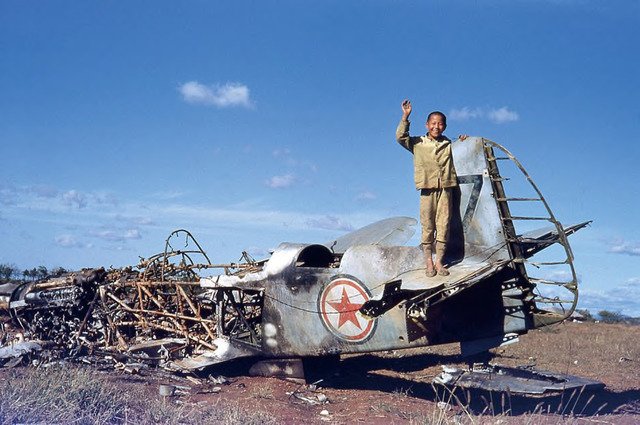 Figure 1. John Rich, A Korean Boy on the remains of a Russian built North Korean Yak fighter plane, c. 1950. Kodachrome. Figure 1. John Rich, A Korean Boy on the remains of a Russian built North Korean Yak fighter plane, c. 1950. Kodachrome.