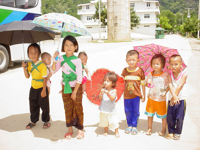 Pao Lor, Children with umbrellas to protect themselves from the hot sun, Wat Tham Krabok Rufugee Camp, 2004-2007. Pao Lor, Children with umbrellas to protect themselves from the hot sun, Wat Tham Krabok Rufugee Camp, 2004-2007.