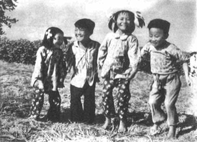 Fig. 4. Yu Chengjian, Jumping for Joy on Top of a Rice Paddy That Is a “Satellite Harvest” of Rice, 1958. The photograph was taken to demonstrate that the rice paddy was so thick it could support four children jumping on top of it. This is one of the most famous images coming out of the feverish reports of fake harvests during China’s Great Leap Forward. 