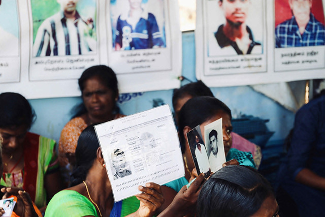 Fig. 5. Protest of the Families of the Disappeared In Maruthankerny, Jaffna: family members hold up photographs of their loved ones, 2018. Most prominent among the various acts of resistance undertaken by the Tamil community are the protests of the Families of the Disappeared in the North and East of Sri Lanka. Continued for over a thousand days since February 2017, the protesters have gathered in various locations to demand answers from the state about the whereabouts of their loved ones, a number of whom surrendered to the state security forces at the end of the war. Photographs of the protesters, haunting in their wielding of hundreds of photographs of missing family members, have become a visual metonym for the many injustices and grievances that pervade the postwar. Photograph by Vindhya Buthpitiya. Fig. 5. Protest of the Families of the Disappeared In Maruthankerny, Jaffna: family members hold up photographs of their loved ones, 2018. Most prominent among the various acts of resistance undertaken by the Tamil community are the protests of the Families of the Disappeared in the North and East of Sri Lanka. Continued for over a thousand days since February 2017, the protesters have gathered in various locations to demand answers from the state about the whereabouts of their loved ones, a number of whom surrendered to the state security forces at the end of the war. Photographs of the protesters, haunting in their wielding of hundreds of photographs of missing family members, have become a visual metonym for the many injustices and grievances that pervade the postwar. Photograph by Vindhya Buthpitiya.