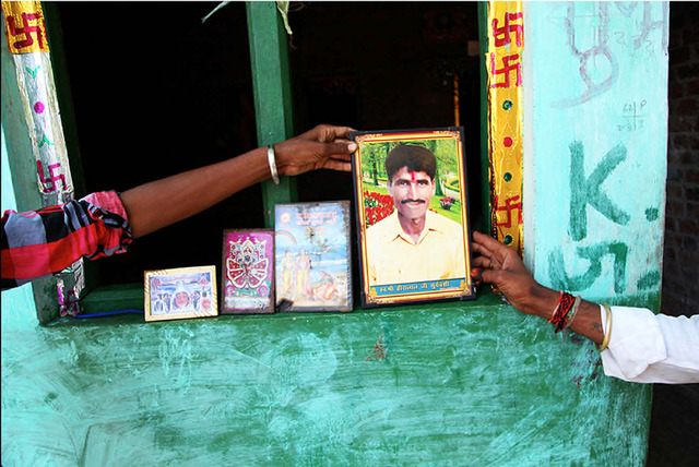 Fig. 14. Gokul’s and Narji’s outstretched arms hold a memorial photograph of Hira. Hira’s portrait was featured on the cover of Camera Indica (it depicted Hira’s brother, Ramlal, holding a portrait of Hira holding a portrait of his father) in a mise-en-abyme, a kind of visual black hole through which the image fell backwards to an impossible moment of past capture. The image of Hira I encountered in 2019 in the breakaway Dalit settlement near the village railway station where his brothers now live seemed to move in the opposite direction, falling forward into a future in which he served as a guide. Gokul, the son of Hira’s brother Naggulal, “thrashed” with the presence of Hira at least twice a year (during each of the “nine nights of the goddess”). The memorial photograph of Hira directly animated the thrashing, Hira’s pret passing from the surface of the image into Gokul’s body. Fig. 14. Gokul’s and Narji’s outstretched arms hold a memorial photograph of Hira. Hira’s portrait was featured on the cover of Camera Indica (it depicted Hira’s brother, Ramlal, holding a portrait of Hira holding a portrait of his father) in a mise-en-abyme, a kind of visual black hole through which the image fell backwards to an impossible moment of past capture. The image of Hira I encountered in 2019 in the breakaway Dalit settlement near the village railway station where his brothers now live seemed to move in the opposite direction, falling forward into a future in which he served as a guide. Gokul, the son of Hira’s brother Naggulal, “thrashed” with the presence of Hira at least twice a year (during each of the “nine nights of the goddess”). The memorial photograph of Hira directly animated the thrashing, Hira’s pret passing from the surface of the image into Gokul’s body.