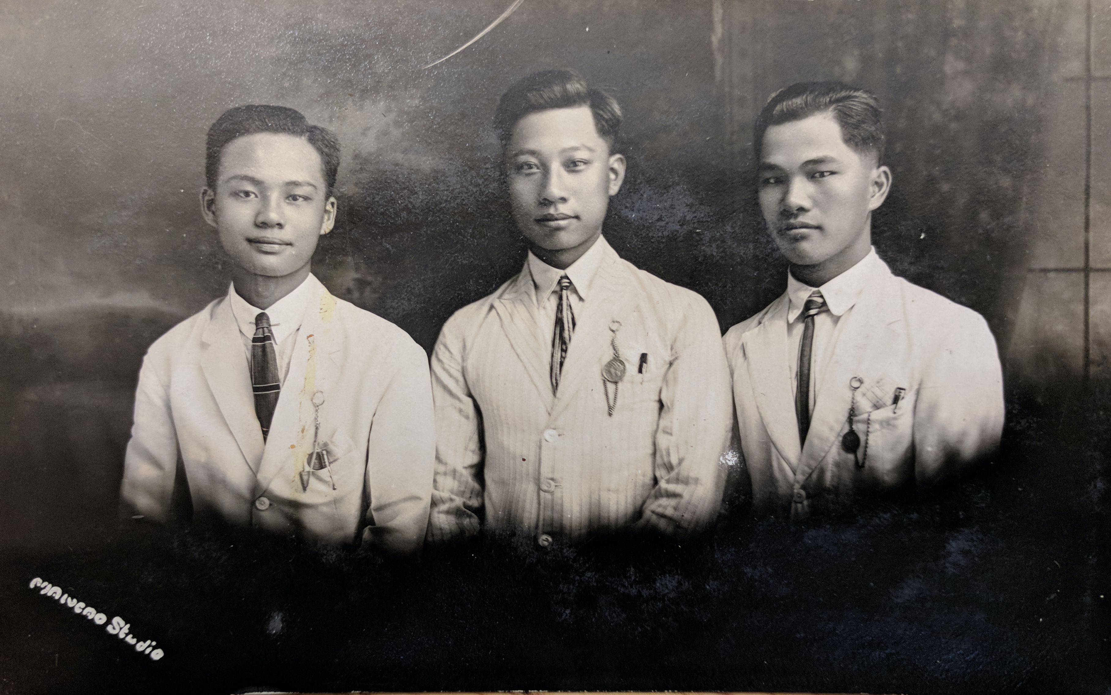 Alt-text: “Three young men in light-colored suits with Masonic pins on their left breast pockets.” Alt-text: “Three young men in light-colored suits with Masonic pins on their left breast pockets.”
