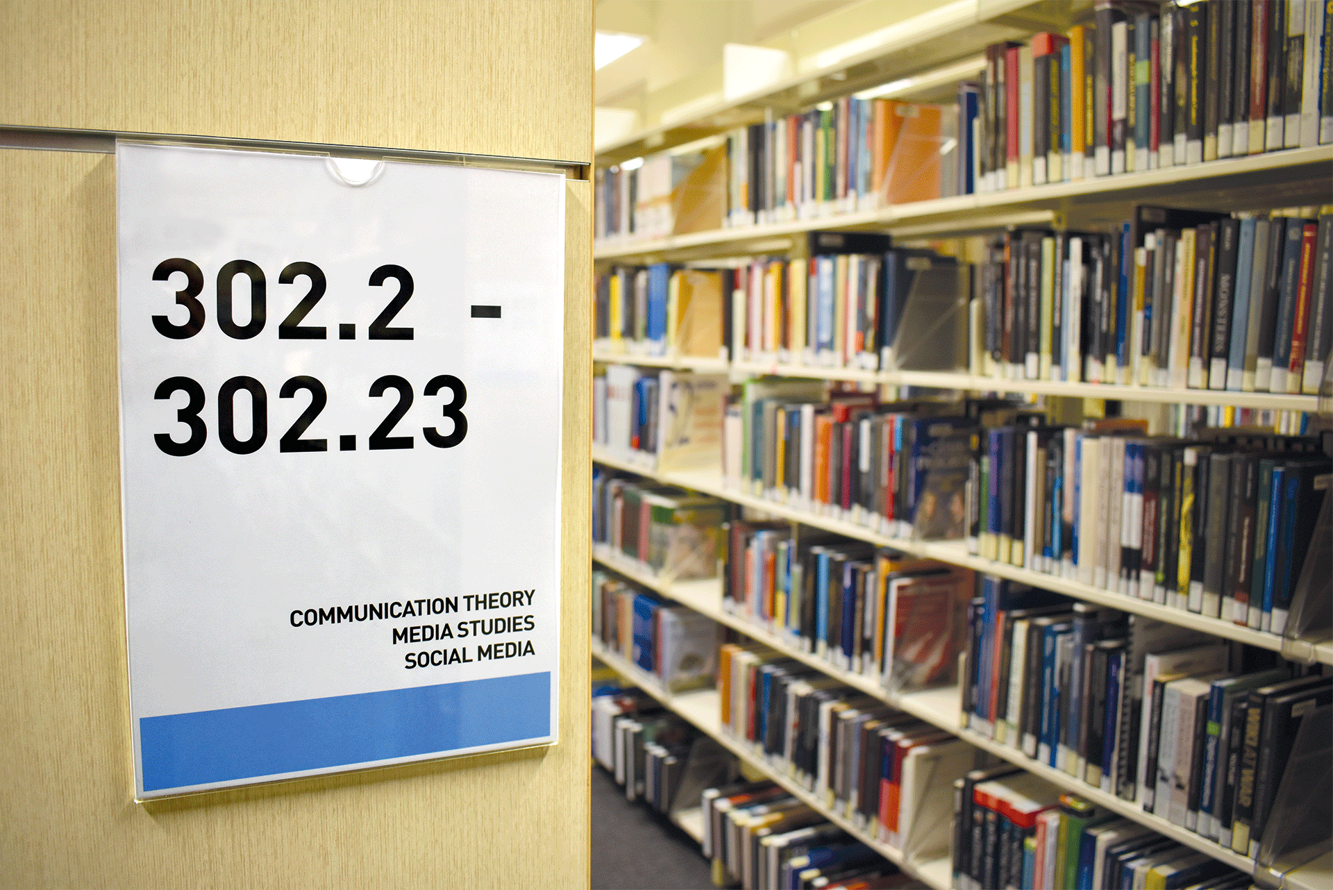 Figure 10. Call number signage uses topic headings to allow for greater discoverability of materials. The colors from the Collection Ribbon are used as a visual clue to assist students locating items. Figure 10. Call number signage uses topic headings to allow for greater discoverability of materials. The colors from the Collection Ribbon are used as a visual clue to assist students locating items.